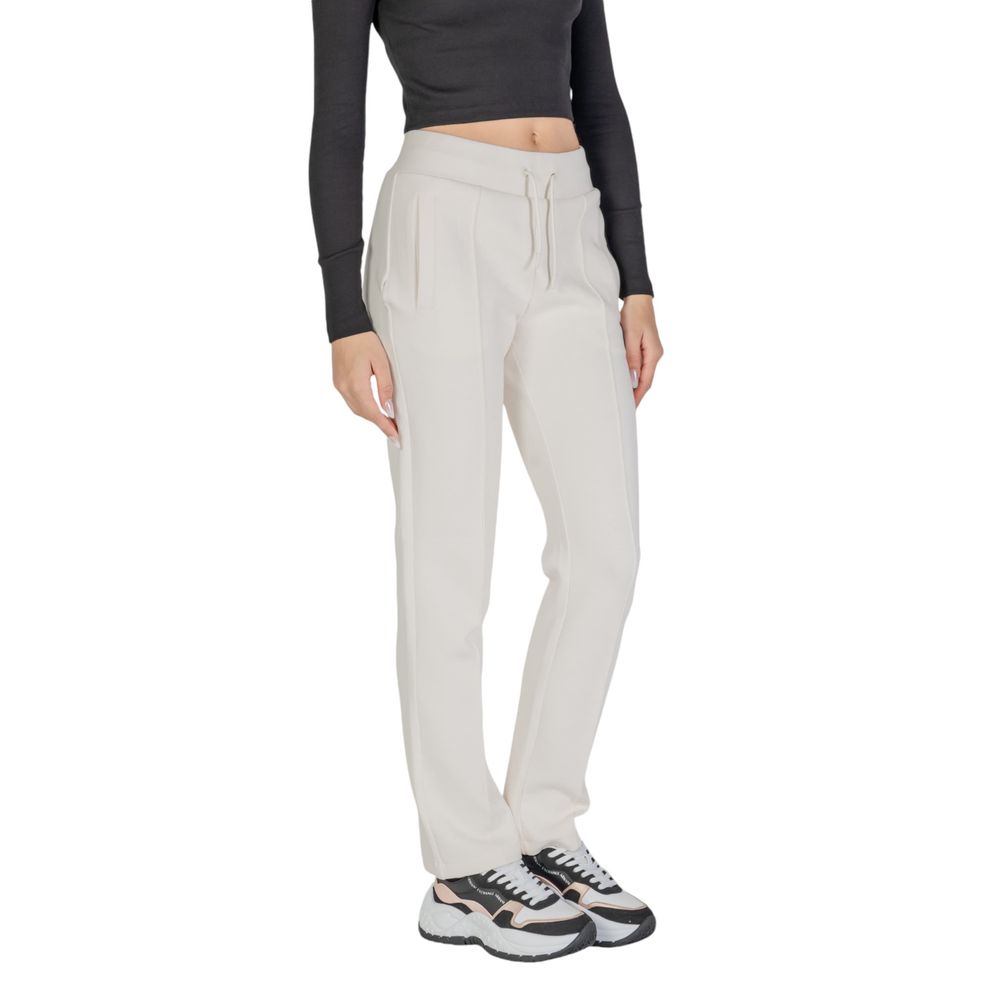 Blugi și pantaloni Guess Active din bumbac crem
