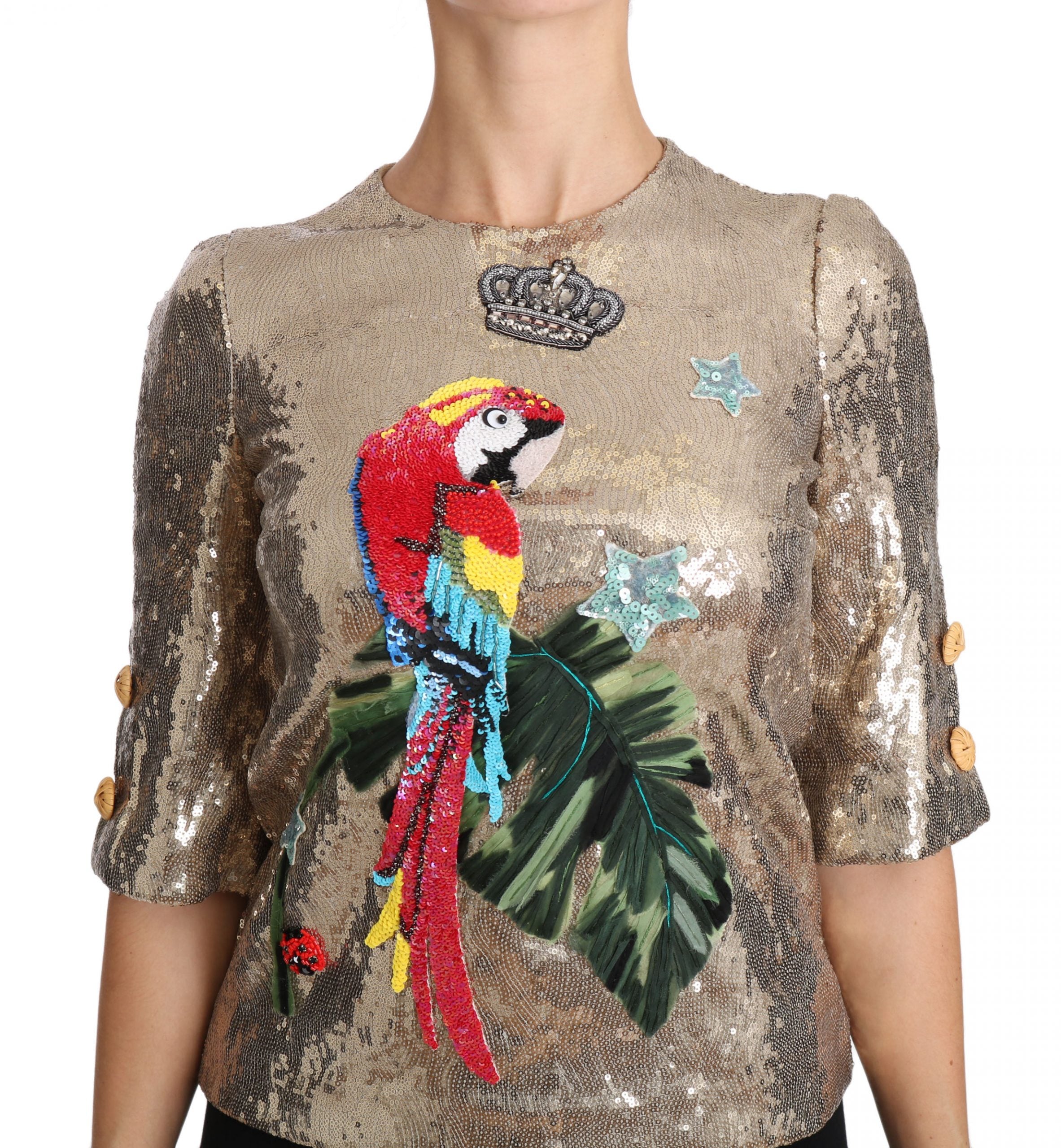 Dolce &amp; Gabbana – Rundhalsbluse mit goldenem Papageienmotiv und Kristallen